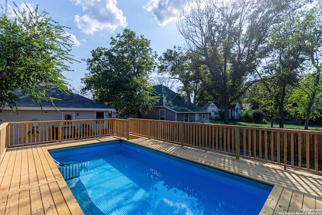 view of swimming pool with a deck