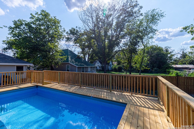 view of swimming pool with a wooden deck