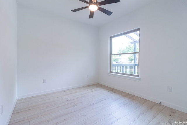 spare room featuring light wood-type flooring and ceiling fan