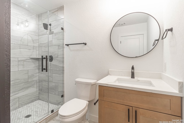 bathroom with vanity, toilet, and an enclosed shower