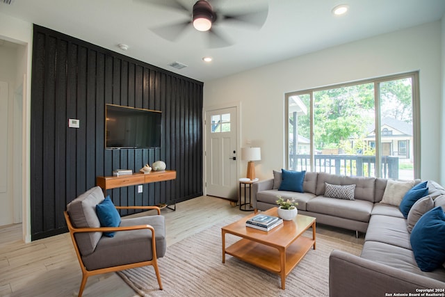 living room with light wood-type flooring and ceiling fan