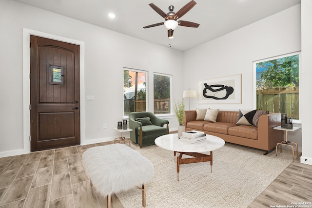 living room with light hardwood / wood-style floors and ceiling fan