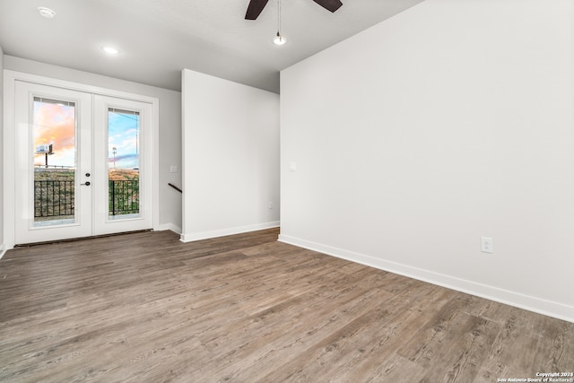 empty room featuring french doors, a textured ceiling, hardwood / wood-style flooring, and ceiling fan