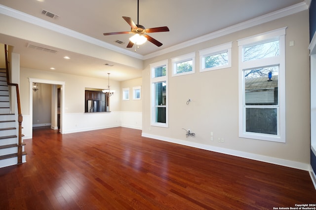 unfurnished living room with ornamental molding, dark hardwood / wood-style flooring, and ceiling fan with notable chandelier