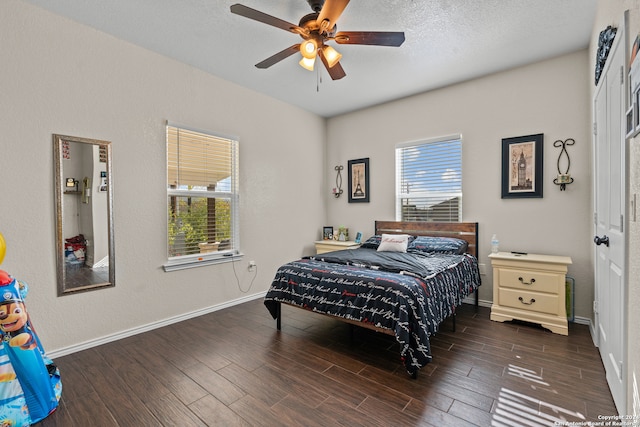 bedroom featuring ceiling fan, a textured ceiling, and dark hardwood / wood-style flooring