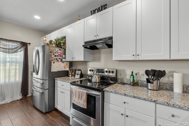 kitchen featuring appliances with stainless steel finishes, white cabinets, light stone countertops, and dark hardwood / wood-style flooring