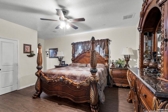 bedroom with ceiling fan, a textured ceiling, and dark hardwood / wood-style flooring