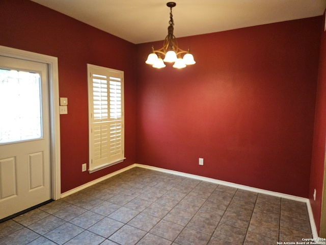 interior space with a notable chandelier, tile patterned floors, and plenty of natural light