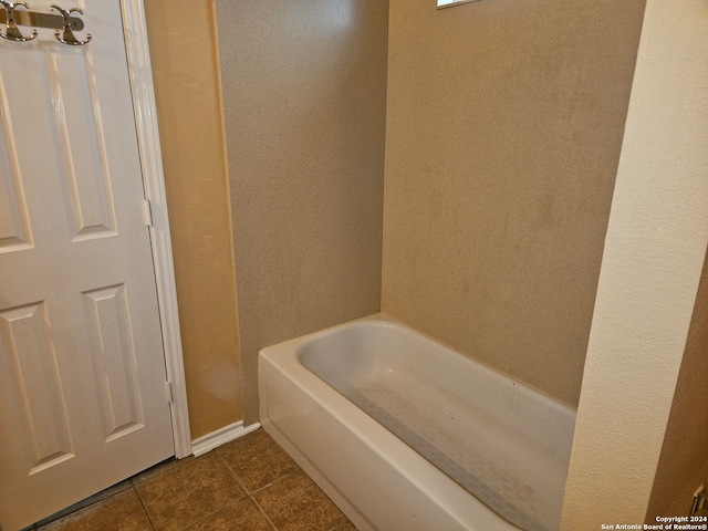 bathroom featuring a tub to relax in and tile patterned flooring