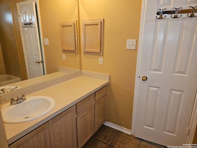 bathroom featuring vanity, a bathtub, and tile patterned flooring