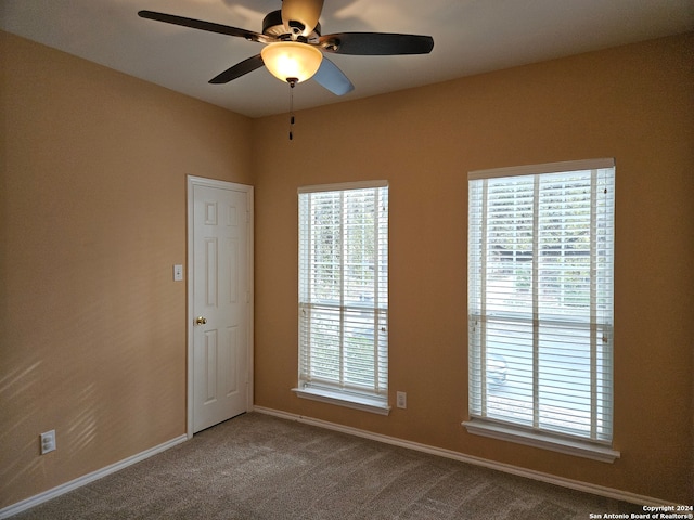 carpeted empty room with ceiling fan