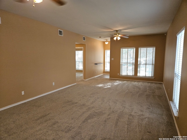 carpeted empty room featuring ceiling fan