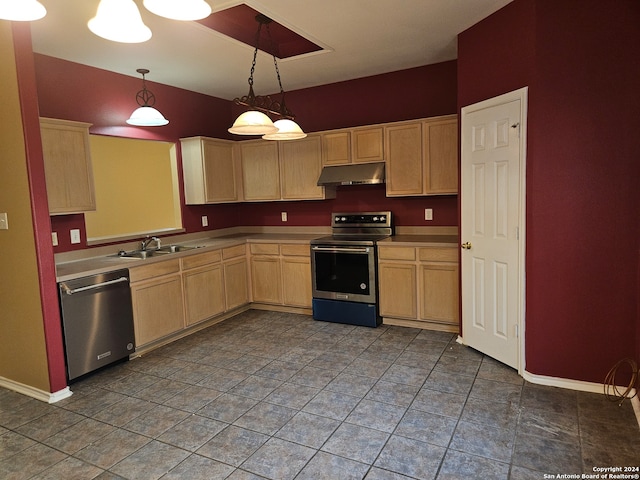 kitchen with dark tile patterned flooring, stainless steel appliances, sink, pendant lighting, and light brown cabinetry