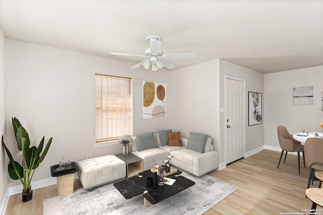 living room featuring ceiling fan and light hardwood / wood-style floors