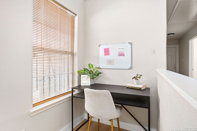 home office with wood-type flooring