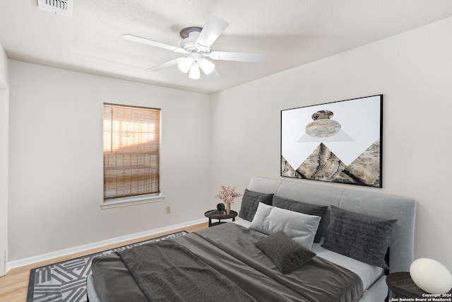 bedroom featuring ceiling fan and light hardwood / wood-style flooring