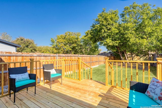 wooden terrace featuring a yard