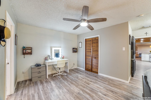 150 S Fisher Ln, Poteet, TX 78065 - home office featuring ceiling fan, baseboards, a textured ceiling, and light wood-style flooring