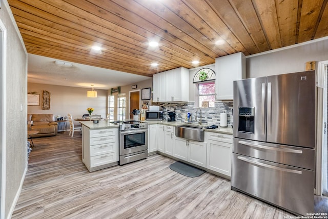 150 S Fisher Ln, Poteet, TX 78065 - kitchen featuring a peninsula, wooden ceiling, a sink, and appliances with stainless steel finishes