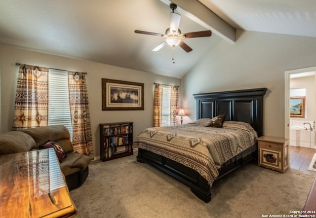 bedroom with hardwood / wood-style floors, lofted ceiling with beams, ensuite bathroom, and ceiling fan