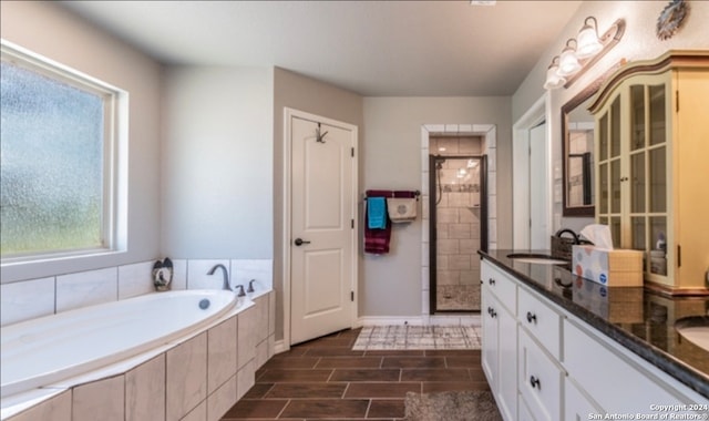 bathroom featuring vanity and independent shower and bath