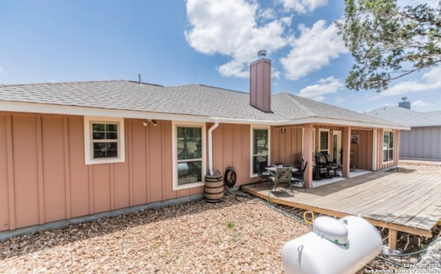 back of house featuring a wooden deck