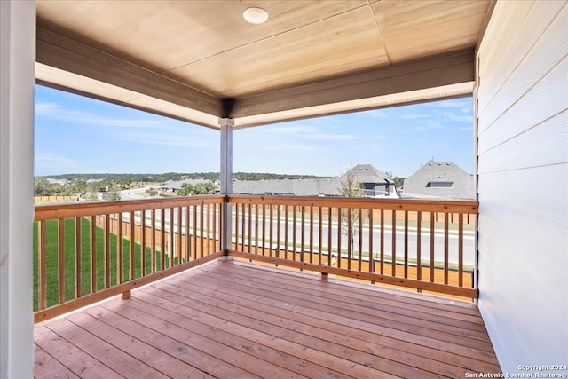 wooden deck featuring a lawn