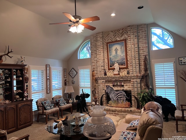 carpeted living room featuring a brick fireplace, a healthy amount of sunlight, high vaulted ceiling, and ceiling fan