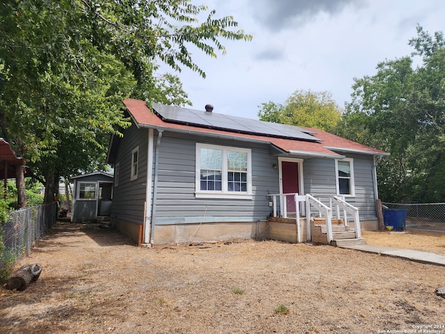 view of front of home featuring solar panels