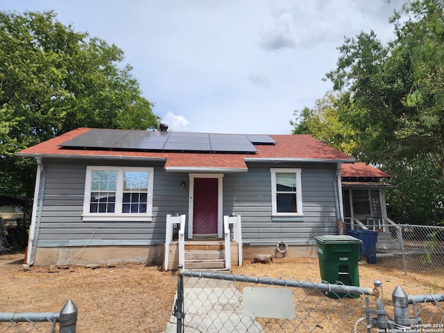 bungalow-style house with solar panels