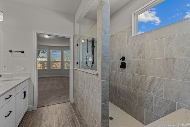 bathroom featuring vanity and a tile shower