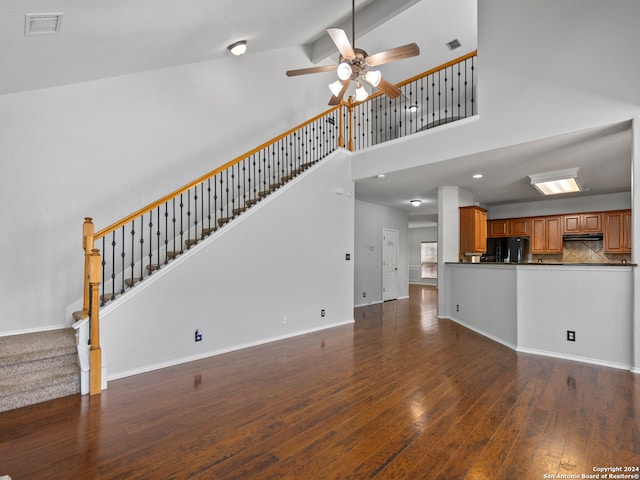 unfurnished living room featuring ceiling fan, high vaulted ceiling, and dark hardwood / wood-style flooring