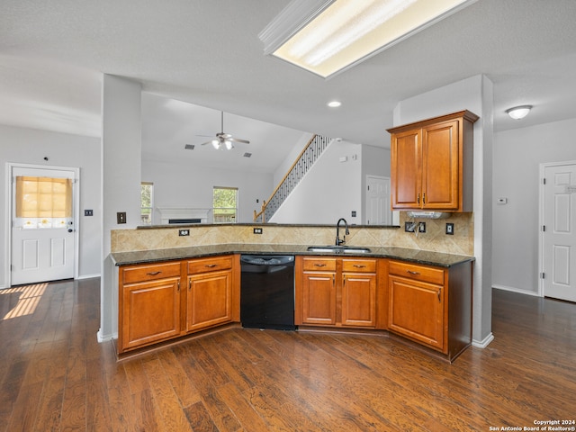 kitchen featuring kitchen peninsula, ceiling fan, dishwasher, dark hardwood / wood-style floors, and sink