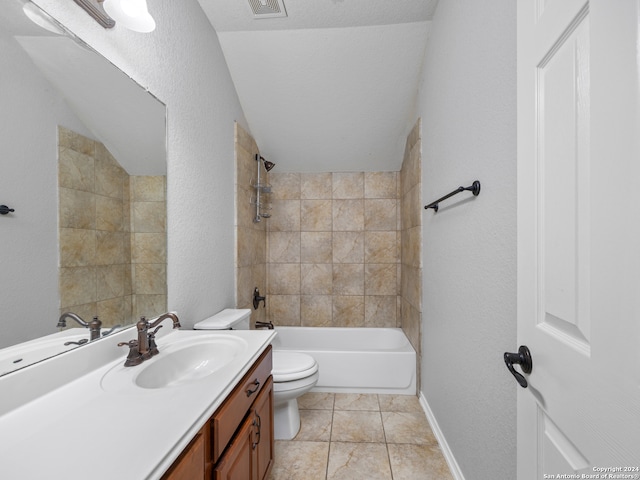 full bathroom featuring tiled shower / bath, a textured ceiling, toilet, vanity, and tile patterned floors