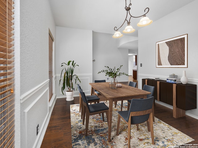 dining room with a notable chandelier and dark hardwood / wood-style floors