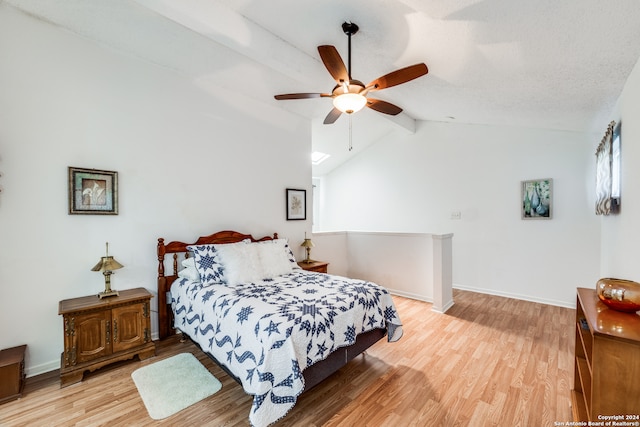 bedroom with lofted ceiling with beams, hardwood / wood-style flooring, and ceiling fan