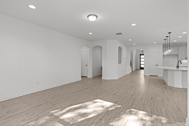 unfurnished living room featuring light hardwood / wood-style flooring