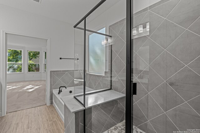 bathroom with shower with separate bathtub