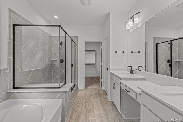 bathroom with vanity and independent shower and bath