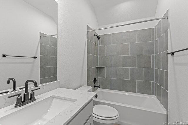 full bathroom with toilet, tiled shower / bath combo, and vanity