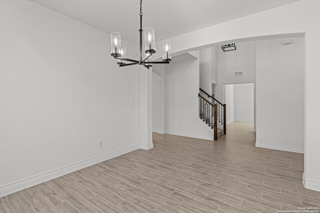 interior space featuring light hardwood / wood-style floors and a chandelier