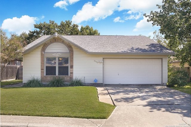 ranch-style home featuring a front lawn and a garage