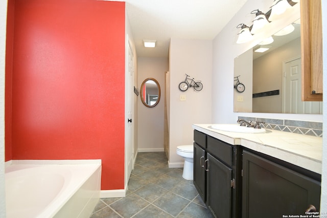 bathroom featuring vanity, toilet, tile patterned floors, and a bathing tub