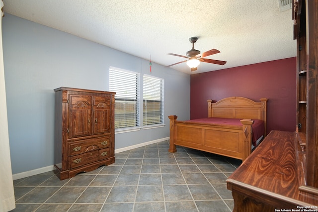 tiled bedroom featuring a textured ceiling and ceiling fan