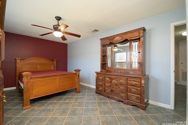 bedroom with a textured ceiling and ceiling fan