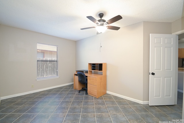 tiled office space with ceiling fan and a textured ceiling