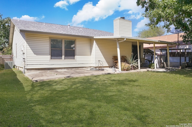 rear view of house featuring a patio area and a lawn