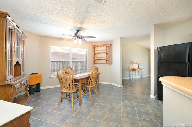 tiled dining room featuring vaulted ceiling, a textured ceiling, and ceiling fan