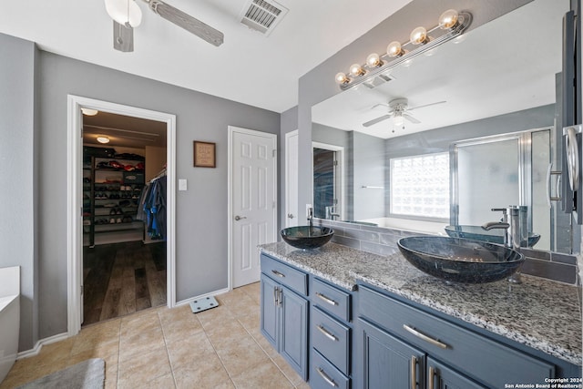 bathroom featuring vanity, ceiling fan, tile patterned floors, and walk in shower