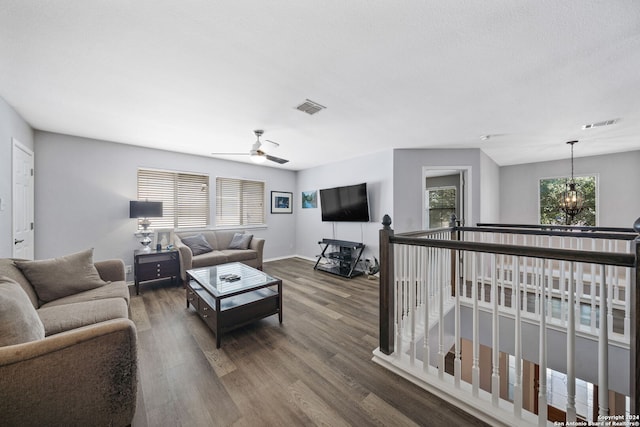 14519 Redwood Vly, San Antonio, TX 78023 - living room featuring ceiling fan with notable chandelier, baseboards, visible vents, and wood finished floors